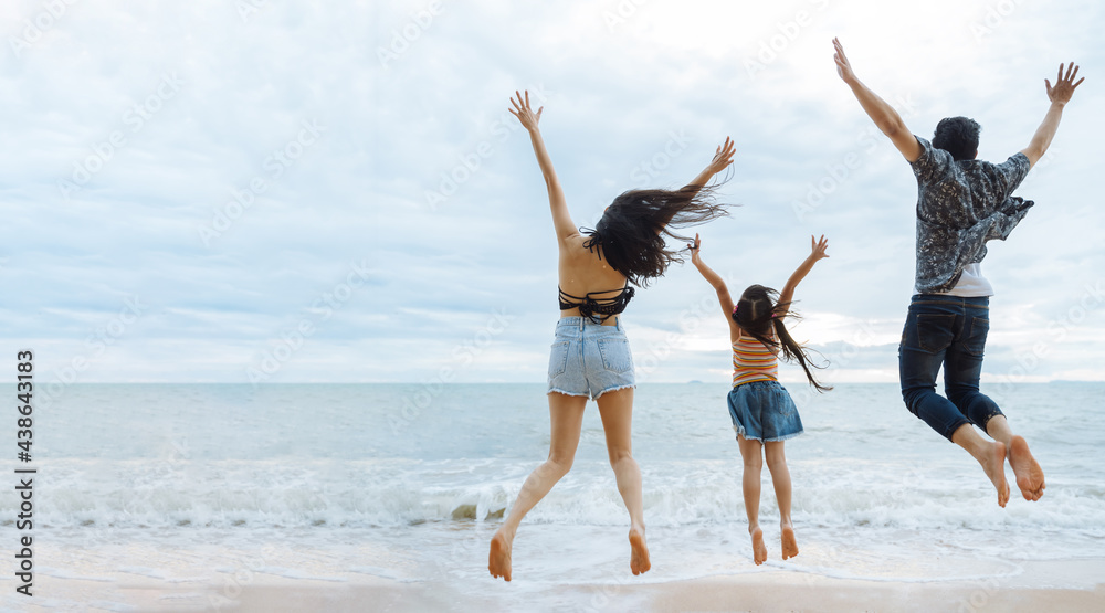 Family jumping together at beach with kids happy vacation travel beach concept
