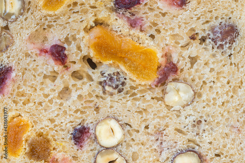 A texture of rye bread slice with cranberry raisin, apricot and hazelnuts