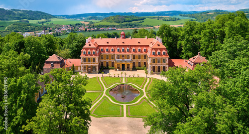 Aerial view of classicist chateau of French style. Large chateau, built by Salm noble family, surrounded by park, trees and hills. Summer, Rájec nad Svitavou, traveling Czech republic. photo