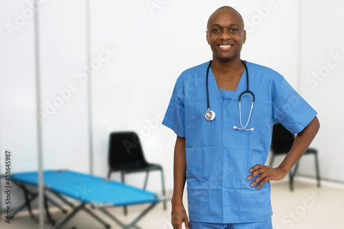 Laughing mature adult afro american male doctor at vaccination station