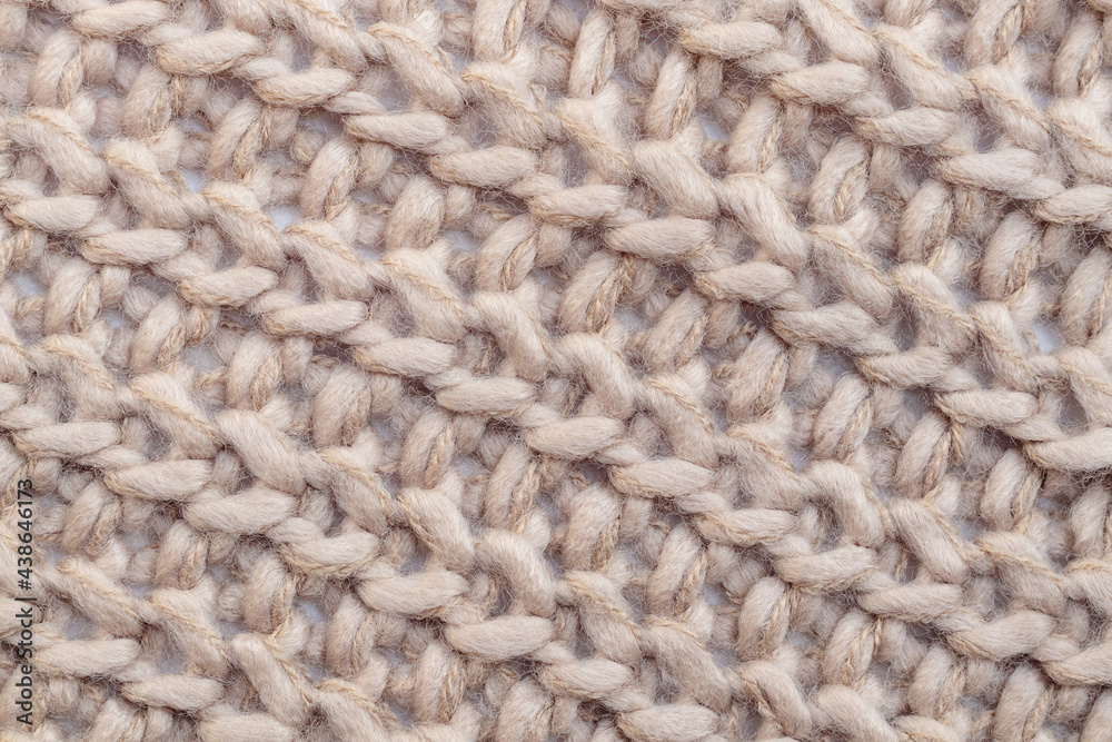 Close up of beige textile texture. Woolen knitted fabric background. Detailed warm woolen scraf. Close up of beige textile texture. Woolen knitted fabric background. Detailed warm woolen scraf.