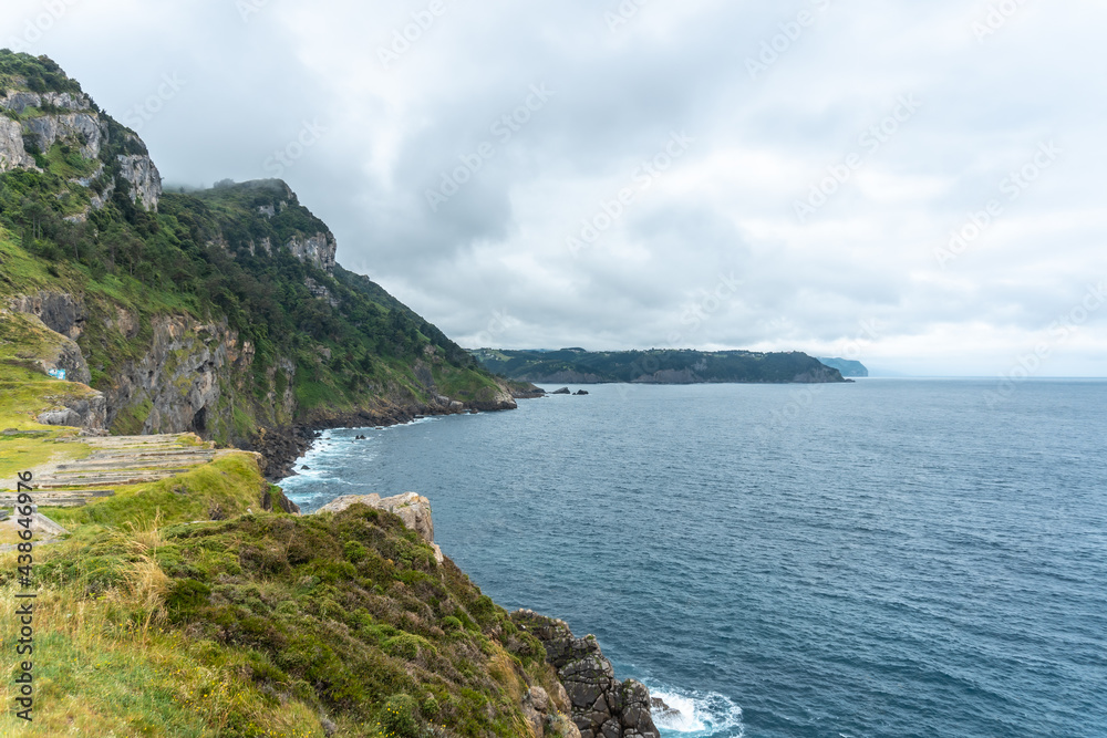 Cliffs next to the Santa Catalina de Lekeitio lighthouse on a cloudy spring morning, with the sea in the background, landscapes of Bizkaia. Basque Country