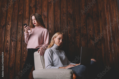 Women with laptop and smartphone working together