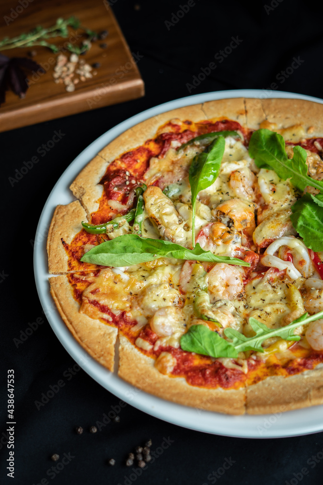 Seafood Pizza ,hand pick pizza, eating pizza and having fun. leisure, food and drinks, people and holidays concept Seafood Pizza ,hand pick pizza, eating pizza and having fun. leisure, food and drinks, people and holidays concept