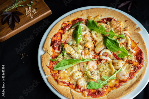 Seafood Pizza ,hand pick pizza, eating pizza and having fun. leisure, food and drinks, people and holidays concept