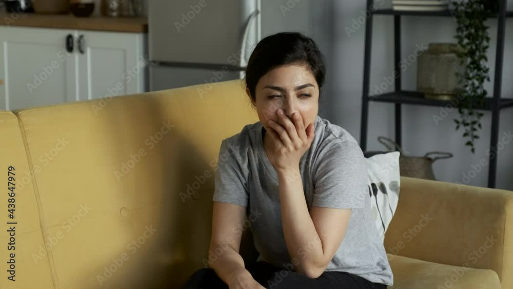 Tired Young Woman Yawns and Lies Down To Rest On The Sofa At Home in The Room Tired Young Woman Yawns and Lies Down To Rest On The Sofa At Home in The Room