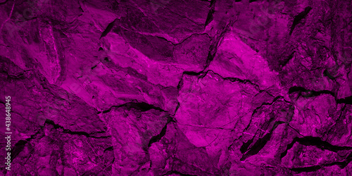 Abstract geometric background. Toned rock texture. Vintage deep purple background with copy space for design. Web banner. Combination of rough mountainous surface with cracks and magenta color.