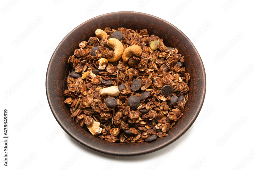 Chocolate granola cereal with nuts in a bowl background. Chocolate granola cereal with nuts in a bowl background.