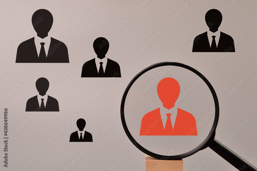 Headhunting and choosing good employee concept. Red employee icon with magnifying glass. Headhunting and choosing good employee concept. Red employee icon with magnifying glass.