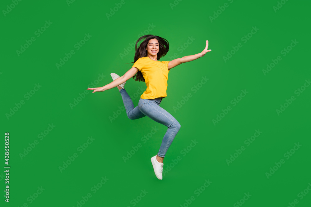 Full length body size side profile photo dreamy girl brunette hair jumping up gracefully ballerina isolated vivid green color background Full length body size side profile photo dreamy girl brunette hair jumping up gracefully ballerina isolated vivid green color background