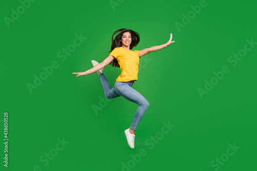 Full length body size side profile photo dreamy girl brunette hair jumping up gracefully ballerina isolated vivid green color background