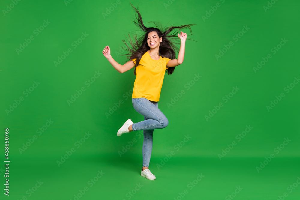 Full length body size photo girl with long brunette hair dancing at party looking copyspace isolated vivid green color background Full length body size photo girl with long brunette hair dancing at party looking copyspace isolated vivid green color background