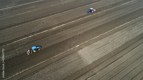 Farmers drive tractors to level up land, North China