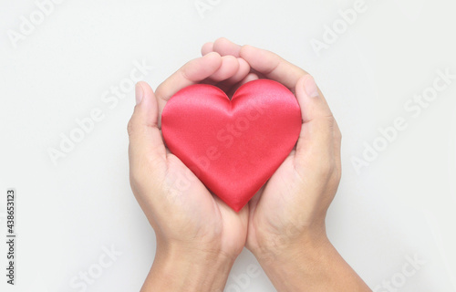 Hands holding red heart. heart health donation concepts