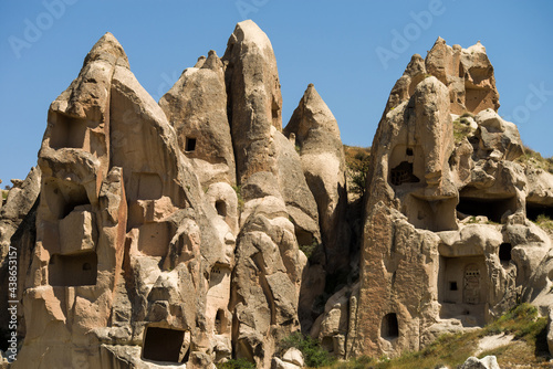 View to cliff dwellings in Cappadocia, Turkey. Ancient cavetown near Goreme.