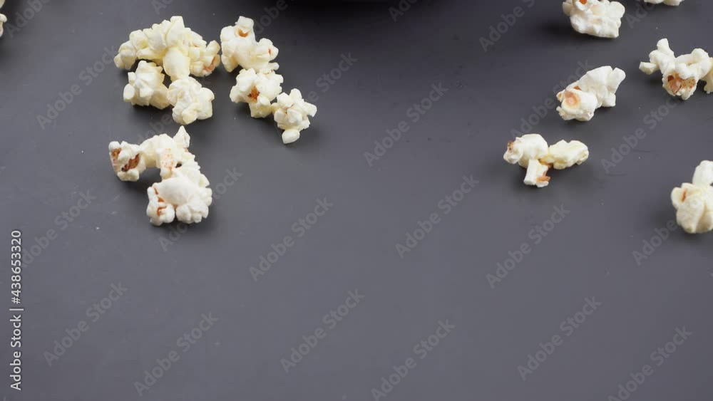 Popcorn in a bowl on a black table, camera movement from the bottom up. Popcorn in a bowl on a black table, camera movement from the bottom up.