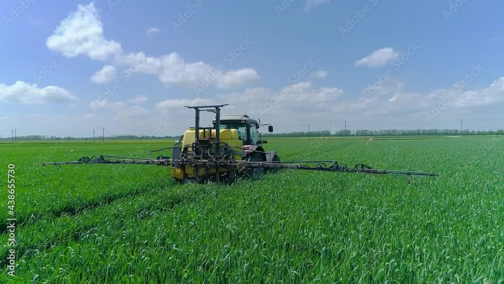 Agricultural Industry.Treatment of Plants in the Fields by Spraying. Spray Nozzle Close-up.The Tractor Moves through the Field working on Pests Agricultural Industry.Treatment of Plants in the Fields by Spraying. Spray Nozzle Close-up.The Tractor Moves through the Field working on Pests