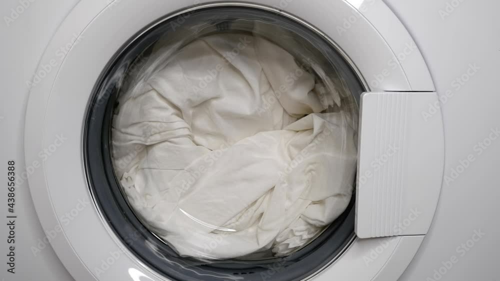 The washing machine is filled with water to wash the bed linen.