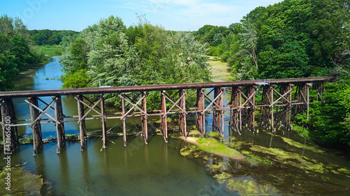 Old wooden railroad train tracks across river