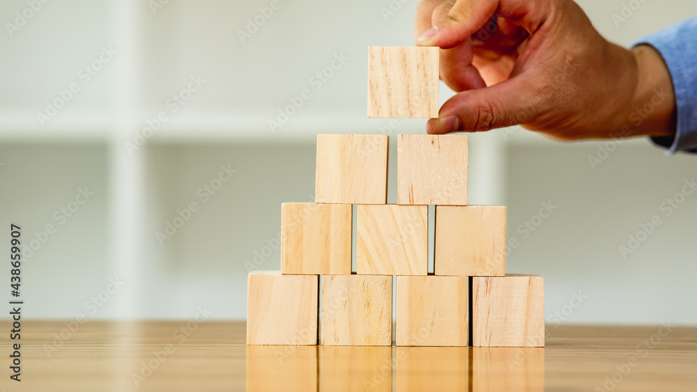 Businessman protect wooden block fall to planning and strategy in risk to business Alternative and prevent. Investment Insurance ,Business risk control concept, Businessman protect wooden block fall to planning and strategy in risk to business Alternative and prevent. Investment Insurance ,Business risk control concept,