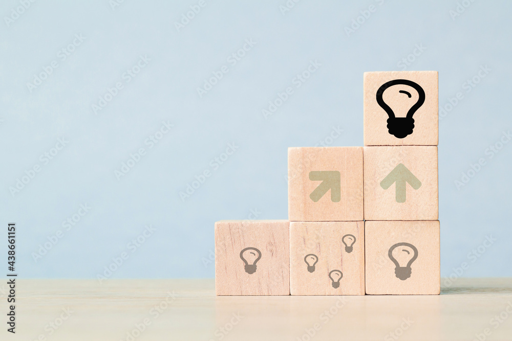 Wooden cubes with icon light bulb symbol. Creative idea and innovation concept. Wooden cubes with icon light bulb symbol. Creative idea and innovation concept.