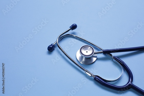 Blue medical stethoscope isolated on blue background