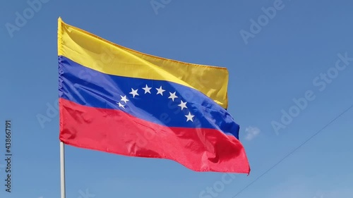 Venezuela. National country flag on blue sky background. Flying fabric symbol. Tourism or travel summer day. international patriotic emblem. Nobody. Horizontal video