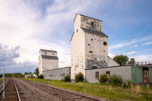 De Winton, Alberta - May 5, 2021: Old grain elevators outside the small town of De Winton, Alberta.