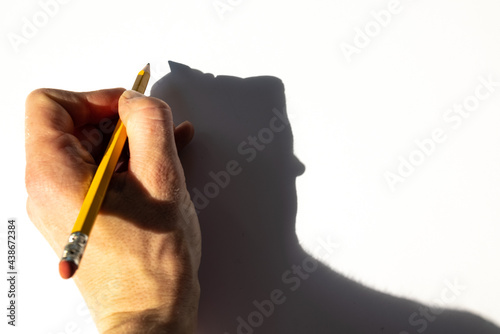 Konstfotografi Hand of a left-handed woman is holding a pencil