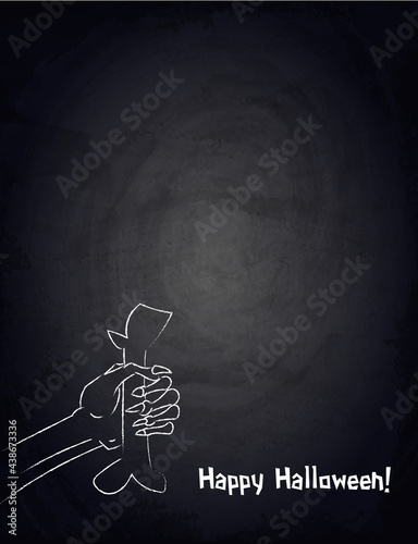 Blackboard background for Halloween design with zombie hand holding bone © darkbird