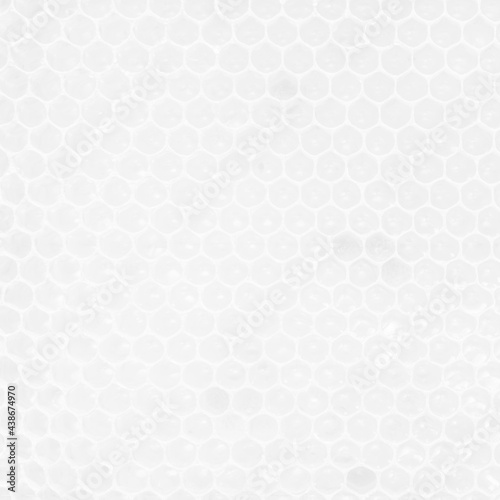 White background texture of honeycombs with fresh raw honey.