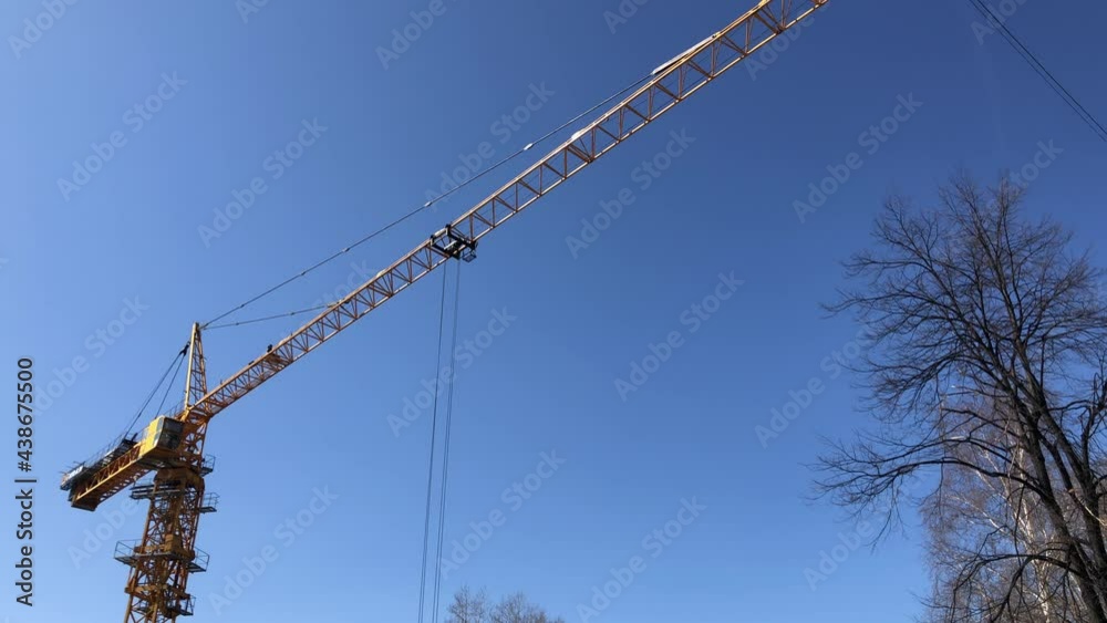 Yellow lift crane in blue sky, construction work. High quality 4k footage Yellow lift crane in blue sky, construction work. High quality 4k footage