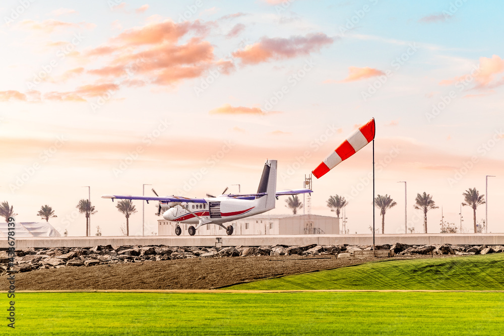 Fototapeta premium The wind sock shows the speed and shear at the airfield during the takeoff of a light twin engine aircraft