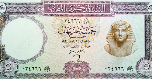 old Five Egyptian pounds banknote 5 LE Issue year 1964 signed by Ahmed Zendo with an image of the pharaoh Tutankhamen on the right and guilloche at bottom center, Leftover currency, vintage retro old. photo