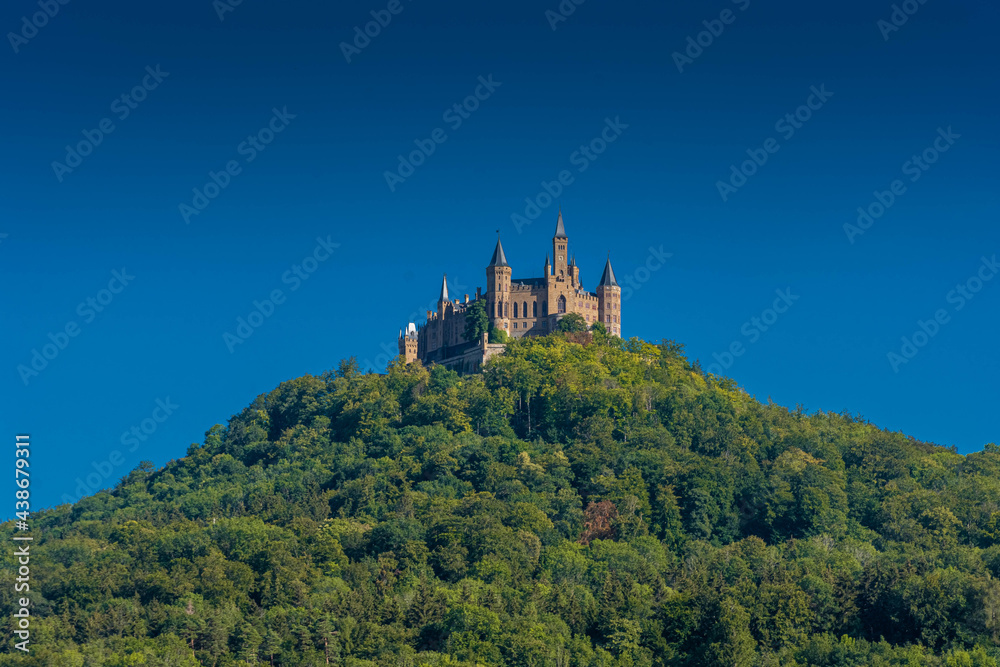 Aerial view of famous Hohenzollern Castle, ancestral seat of the imperial House of Hohenzollern and one of Europe's most visited castles, on the top of a green hill in Baden-Wurttemberg, Germany