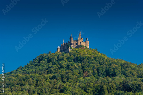 Aerial view of famous Hohenzollern Castle  ancestral seat of the imperial House of Hohenzollern and one of Europe s most visited castles  on the top of a green hill in Baden-Wurttemberg  Germany