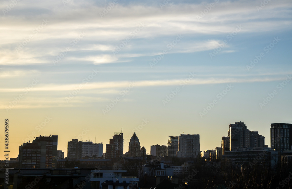 Panorama view of Kyiv cityscape with silhouette of buildings against sunset sky, Ukraine
