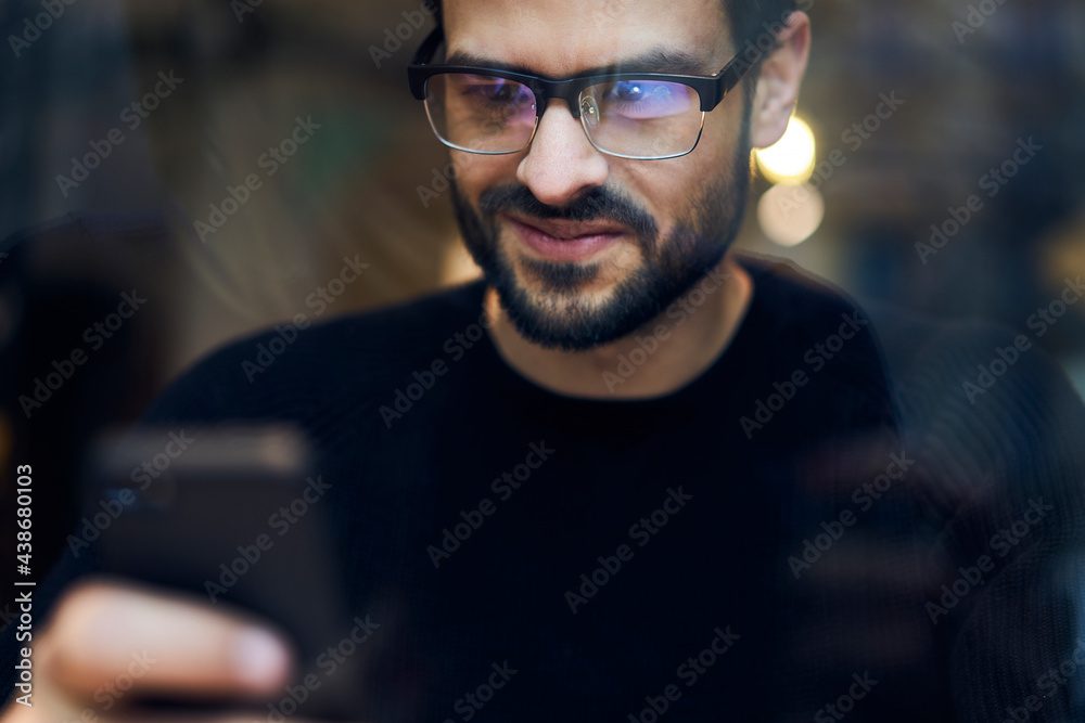 Serious ethnic man browsing smartphone Serious ethnic man browsing smartphone