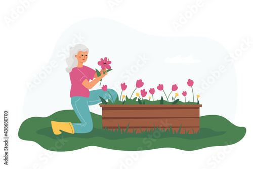 A happy elderly woman growing flowers.