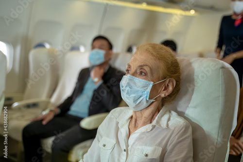 Obraz na plátne Passengers wearing protective mask to Protect Against Covid-19 in planes,New normal travel after covid-19 pandemic concept