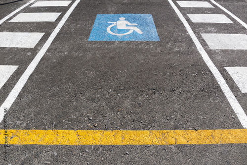Wheelchair parking space on outdoors. Traffic sign handicapped symbol painted on asphalt © Formatoriginal