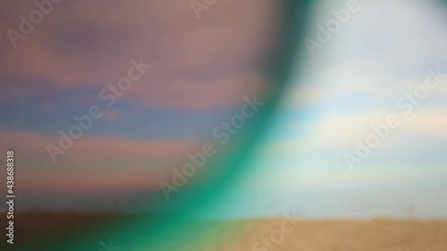 man putting on sunglasses on the beach first-person view