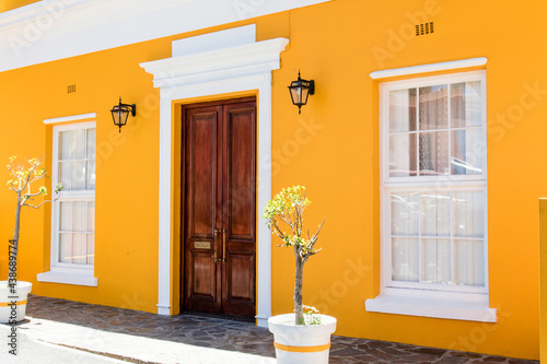 Facade of a yellow colonial house in Bo Kaap neighborhood, Cape Town, South Africa, Africa