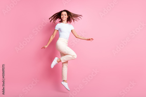 Full size profile photo of optimistic nice brunette hair lady jump wear t-shirt pants isolated on pink background