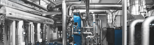 Modern industrial gas boiler room equiped for heating process with heating gas boilers, pipe lines, valves. Panoramic view, composed mixed media. Blue toning.