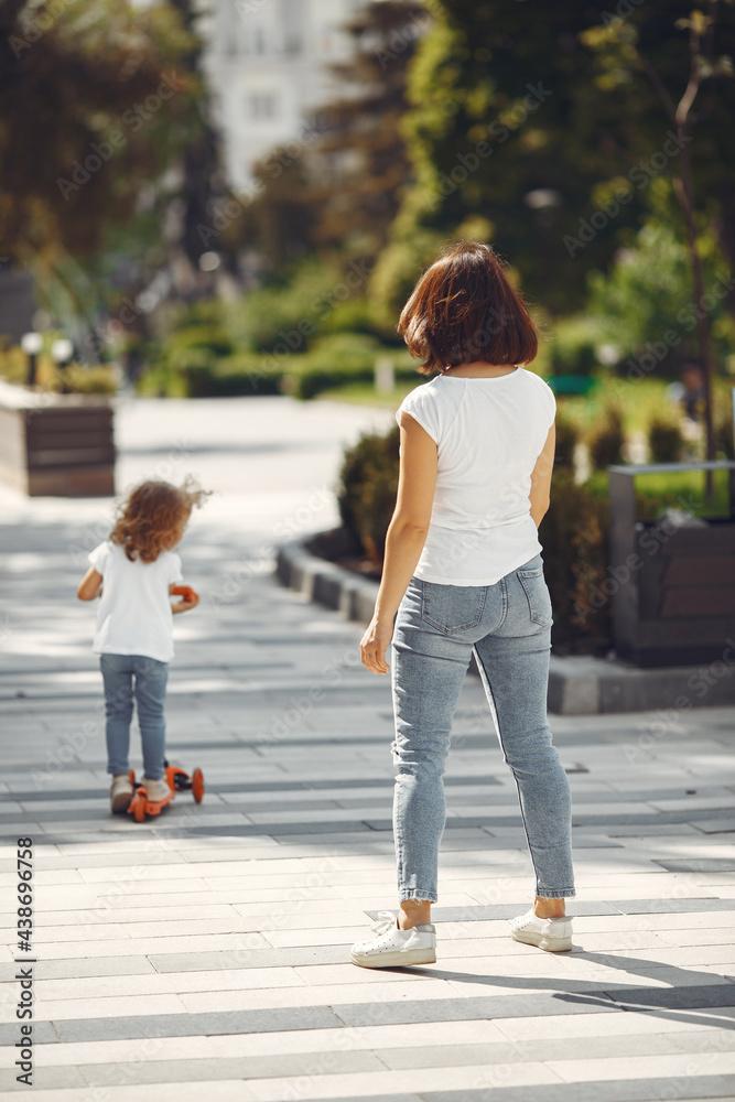 Mother with daughter in a spring park with skate Mother with daughter in a spring park with skate