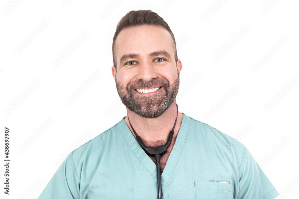Fototapeta premium Smiling mam in scrubs and stethoscope faces camera with white background