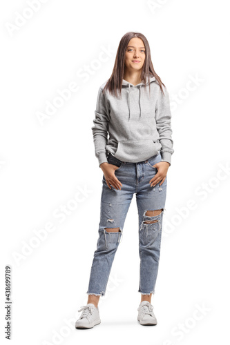 Full length portrait of a young female wearing a hoodie and ripped jeans