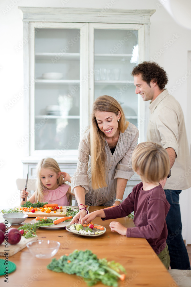 Family preparing a healthy meal in the kitchen at mediterranean home.
Family preparing a healthy meal in the kitchen at mediterranean home.