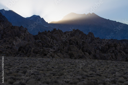 Dramatic sunrays burst over the Sierra Nevada mountains at sunset